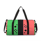 A duffel bag featuring a Nintendo Switch Joy-Con controller design with vertical panels of pink, green, and black, complete with black handles and a detachable shoulder strap, set against a plain white background.
