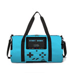 A bright turquoise blue duffel bag designed to look like a retro handheld game console, featuring black straps, a black directional pad, and a screen that reads 'START GAME'.