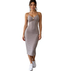 Woman wearing a taupe dress on a white background