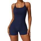 Navy blue swimsuit worn by a model on a white background